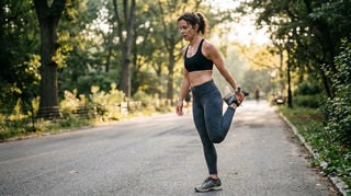 Woman stretching outdoors on a path with trees and sunlight