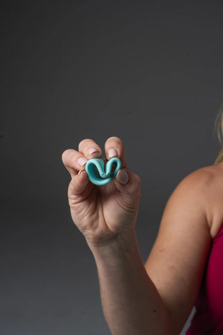 Woman holding a folded Cntrl+ to demonstrate flexibility