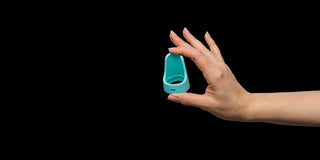 Hand holding Cntrl+ against a black background